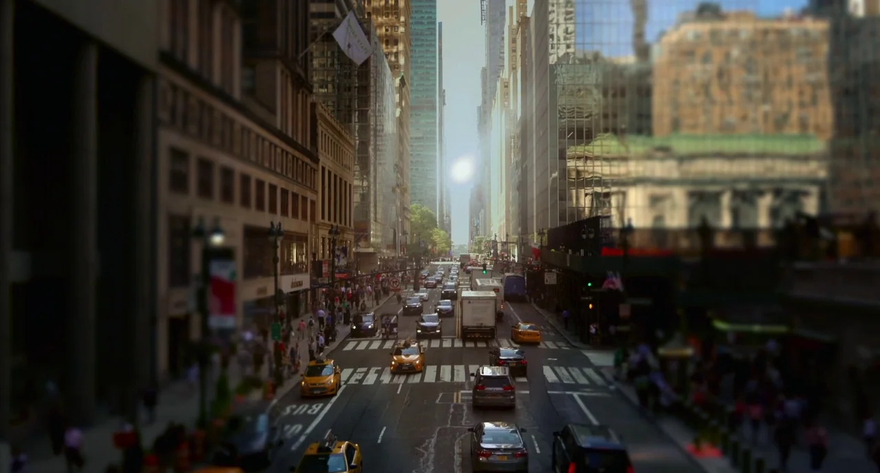 Rabid (2019) movie still: wide — A tall urban street in Manhattan with high-rise buildings framing the thoroughfare. Vehicles and pedestrians move…