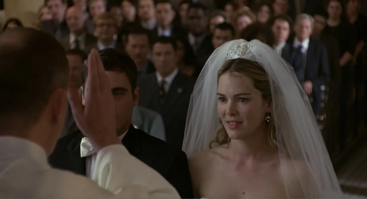 Ladder 49 (2004) movie still: medium — An interior view of a church with a crowded congregation behind the couple. A woman in a white wedding veil…