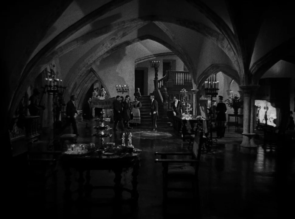 The Bride of Frankenstein (1935) movie still: wide — A large stone vaulted room with gothic arches, stone columns, and a central staircase. Several…
