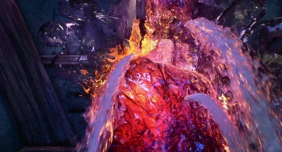 Elemental (2023) movie still: closeup — A fractured red crystal rests on a dark wooden surface in a workspace. Clear liquid pours continuously over…
