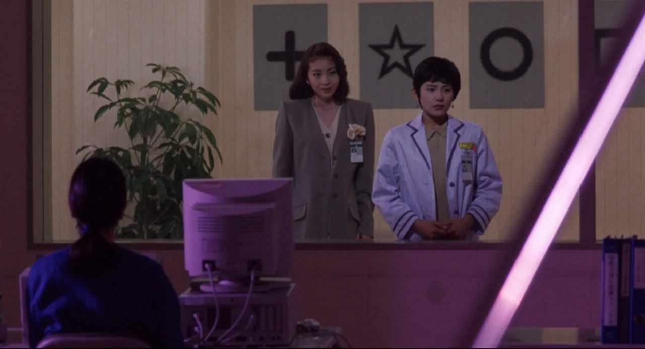 Godzilla vs. SpaceGodzilla (1994) movie still: medium — An office interior features a glass partition decorated with large black symbols on panels.…