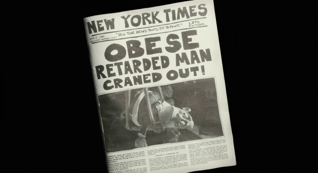 Mary & Max (2009) movie still: closeup — A New York Times front page is centered against an undifferentiated black background. The headline reports…