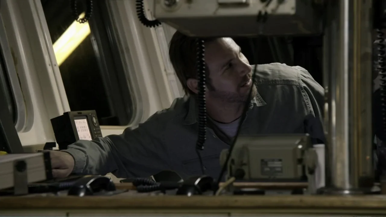 Megalodon: The Monster Shark Lives (2013) movie still: medium — A dark ship command bridge contains technical communication consoles and radio…