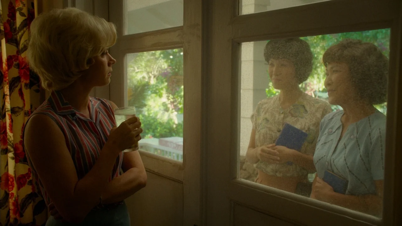Big Eyes (2014) movie still: medium — A woman stands inside a room beside a floral curtain, looking out a glass door. Two other women holding small…