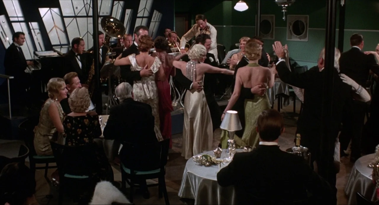What’s the Matter with Helen? (1971) movie still: wide — A 1930s ballroom decorated in art deco style features green walls and large windows.…