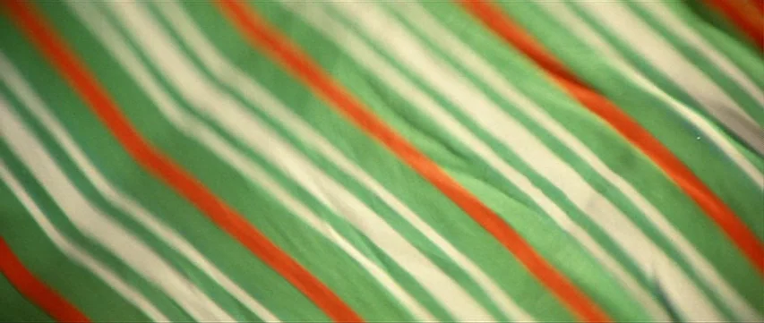 Lone Wolf: Baby Cart at the River Styx (1972) movie still: closeup — A close-up view of a fabric textile featuring diagonal stripes in green and…