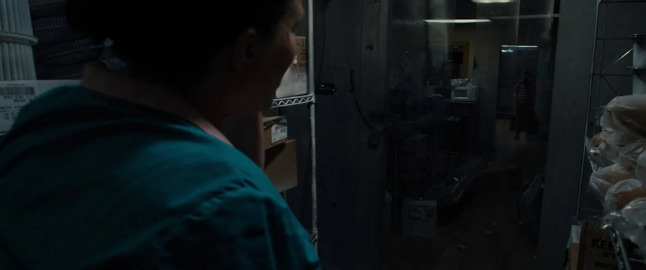 Brightburn (2019) movie still: medium — A cluttered storage room features metal wire shelving filled with boxes and plastic-wrapped goods. In the…