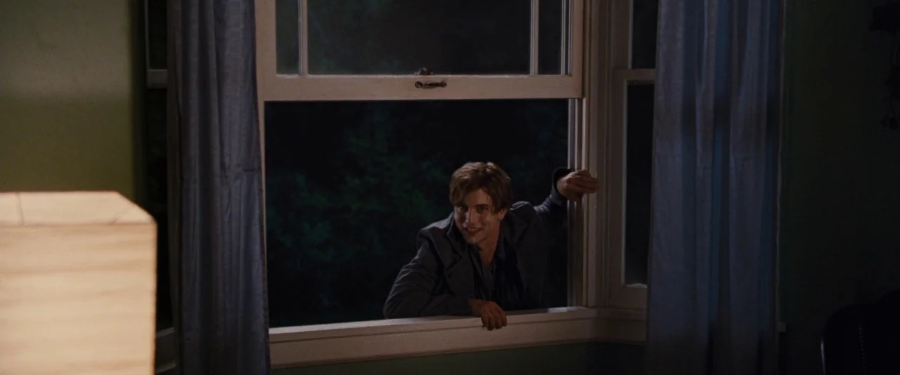 The Twilight Saga: Breaking Dawn – Part 1 (2011) movie still: medium — A dark bedroom interior with blue curtains frames an open window at night. A…