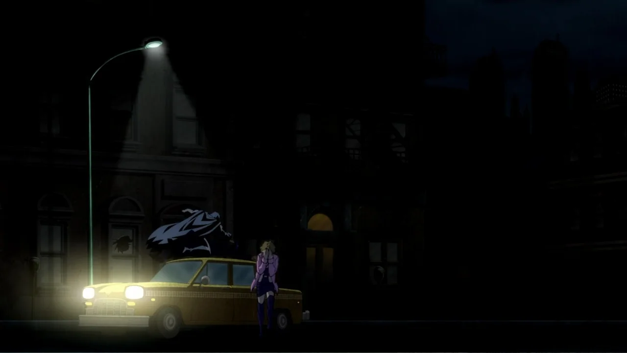 Batman: The Dark Knight Returns, Part 1 (2012) movie still: wide — A dark, rain-slicked city street features an old yellow taxi parked under a lamp.…