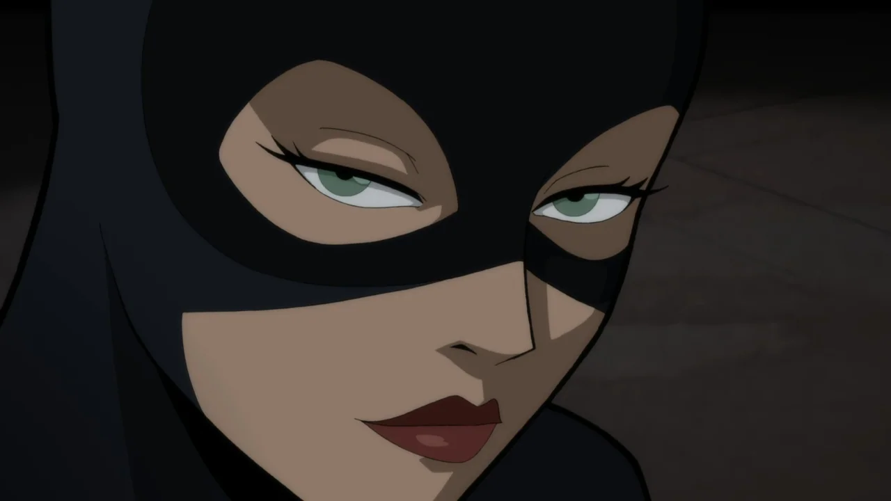 Batman: The Long Halloween, Part One (2021) movie still: closeup — A dark, plain background suggests a nighttime setting on a city rooftop. A woman…