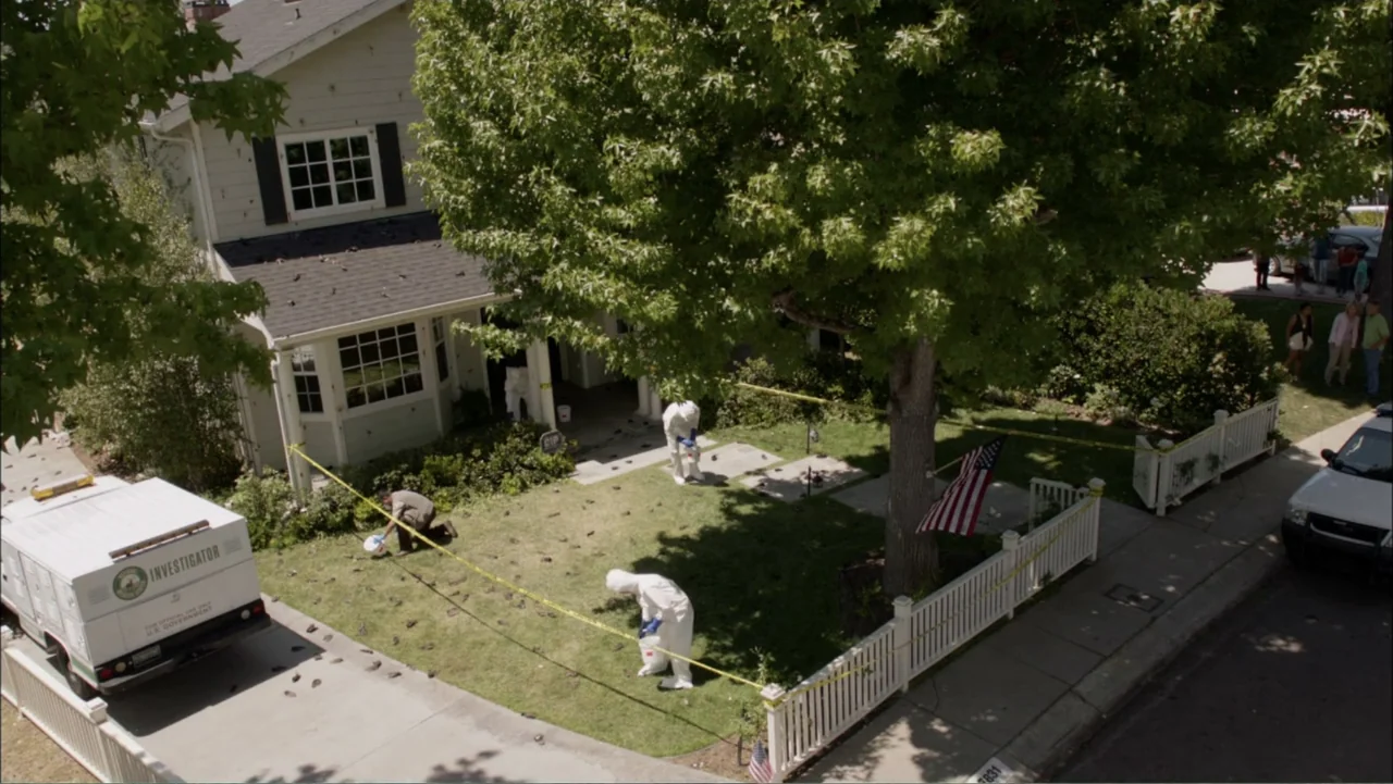 Dark Skies (2013) movie still: wide — A suburban house is cordoned off with yellow tape while investigators work outside. Several figures in…