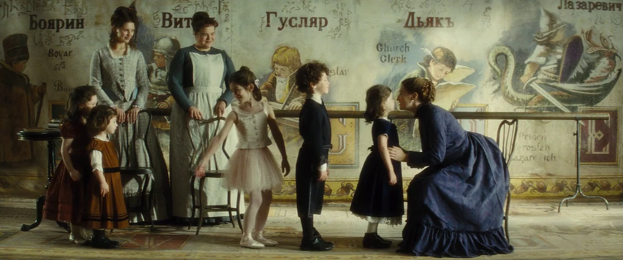Anna Karenina (2012) movie still: wide — A high-ceilinged room features walls decorated with elaborate instructional murals depicting figures in…