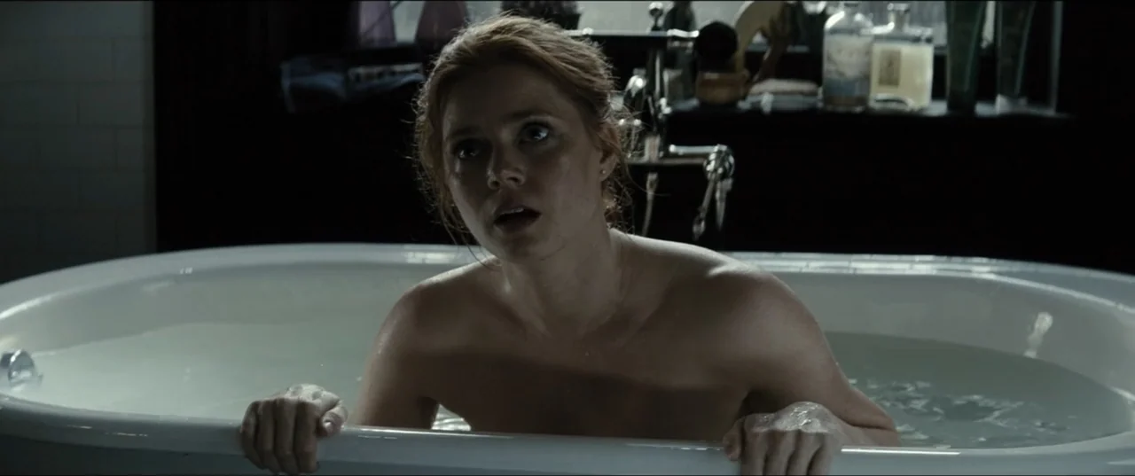Batman v Superman: Dawn of Justice (2016) movie still: medium — A dark, dimly lit space contains a white freestanding tub filled with water. A woman…