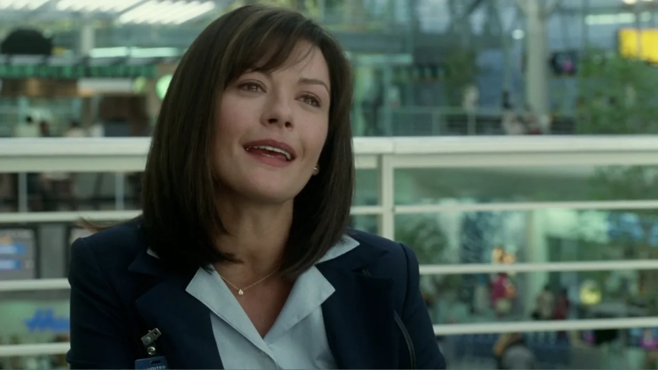 The Terminal (2004) movie still: medium — An interior airport terminal area with bright daylight reflecting off white structural supports. A woman…