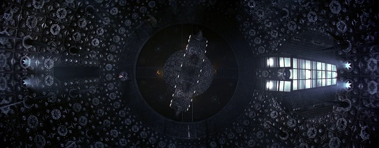 Event Horizon (1997) movie still: establishing — An expansive, intricately carved domed ceiling features repeated star and floral geometric…