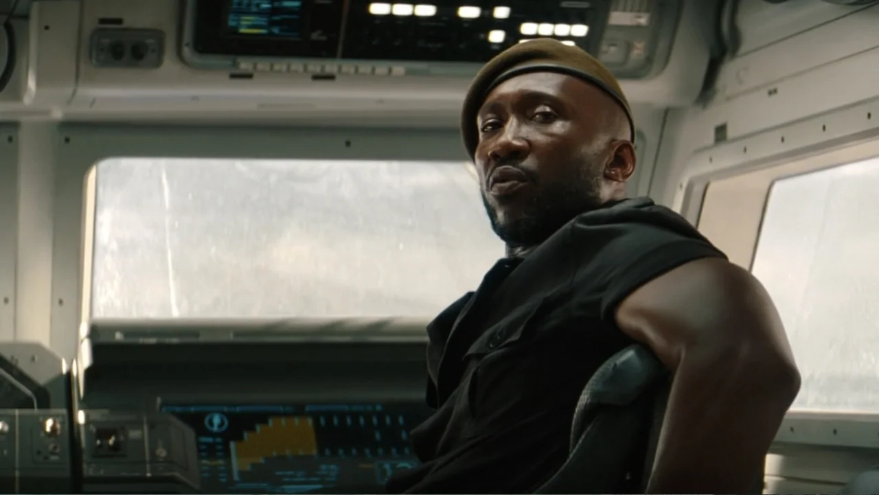 Jurassic World Rebirth (2025) movie still: medium — A high-tech cockpit with illuminated control consoles and large observation windows. A…