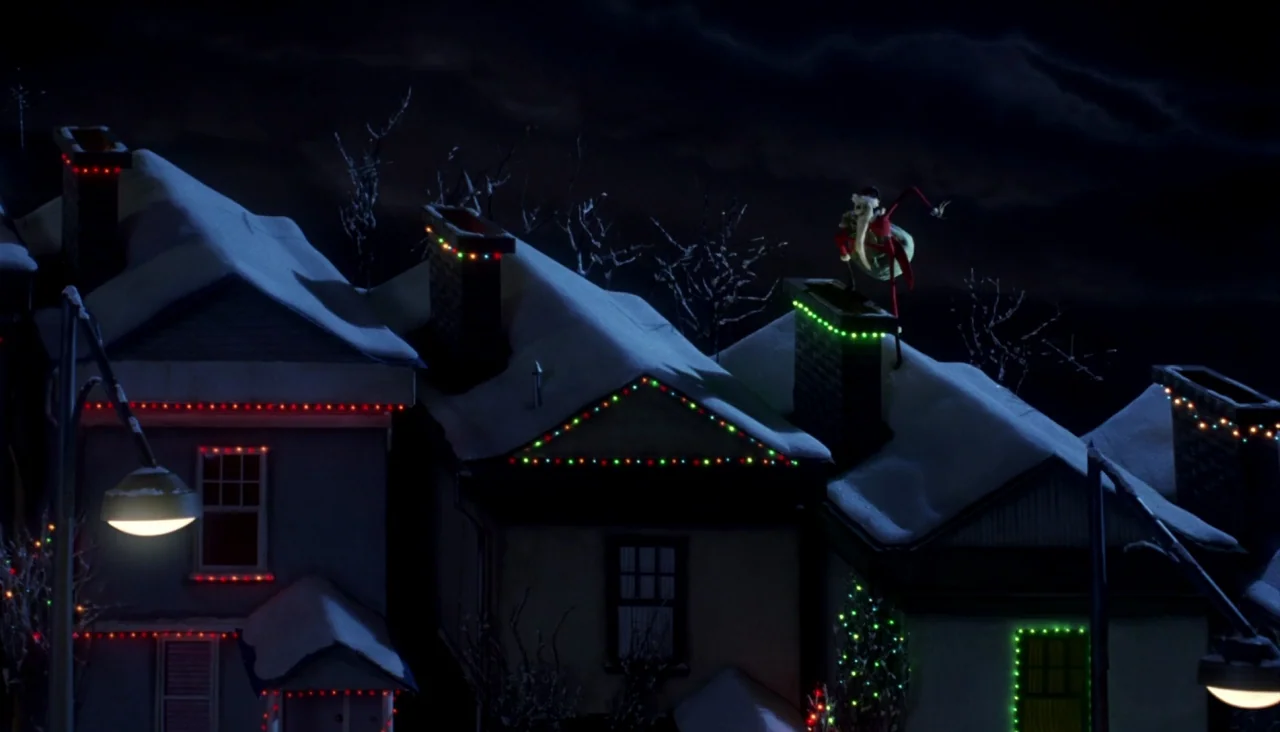 The Nightmare Before Christmas (1993) movie still: wide — A row of houses at night are covered in a layer of fresh snow. A tall skeletal figure…