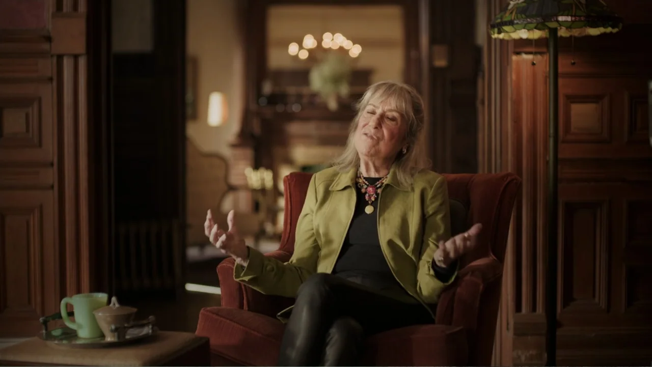 Dear Ms.: A Revolution in Print (2025) movie still: medium — An interior space features wood-paneled walls and an antique fireplace in the blurred…