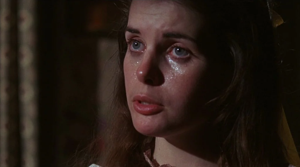 The Ballad of Cable Hogue (1970) movie still: closeup — A dark indoor space provides a neutral, dimly lit background for the character. A young…