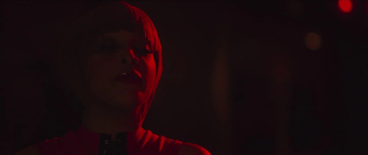Da Sweet Blood of Jesus (2014) movie still: closeup — A dimly lit space is dominated by an intense red light source. A woman with a short bob…