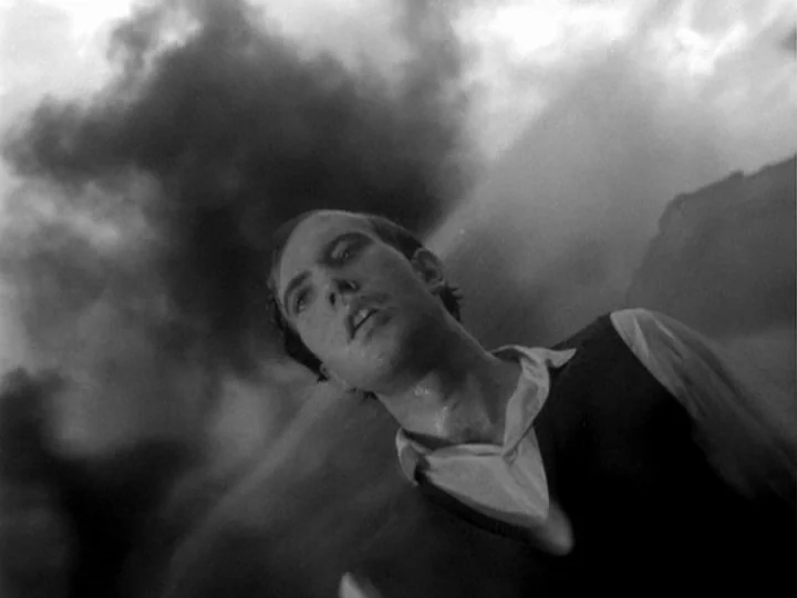 I Am Cuba (1964) movie still: medium — A man stands outdoors under a dark, dramatic sky filled with heavy storm clouds. He looks up toward the sky…
