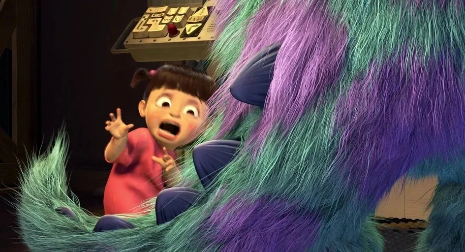 Monsters, Inc. (2001) movie still: medium — An industrial facility features a control panel with chunky buttons and levers. A small girl stares in…