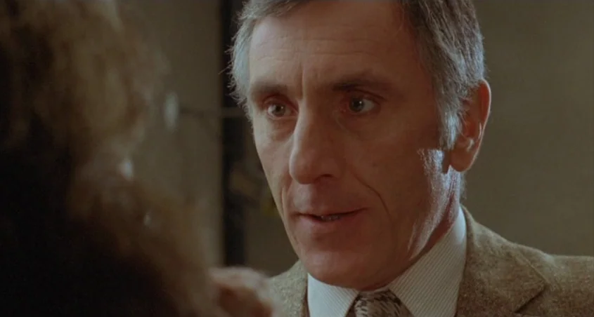 Scanners (1981) movie still: closeup — An indoor space features a man in professional attire during the daytime. The subject looks directly at…