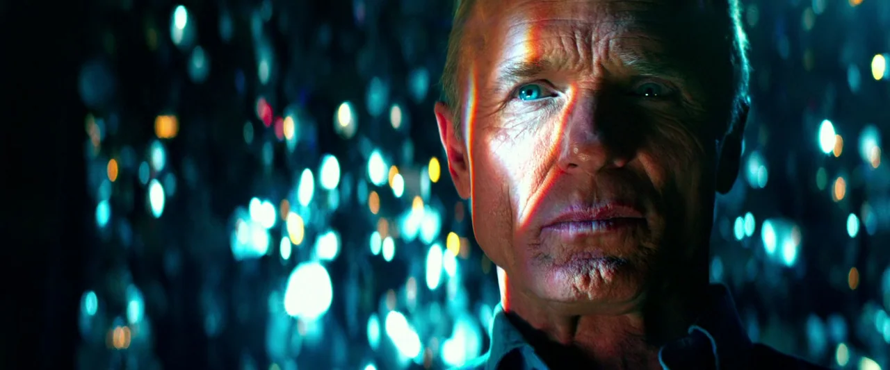 Pain & Gain (2013) movie still: closeup — A man's face appears in high detail against a blurred field of blue light orbs. He remains static while a…