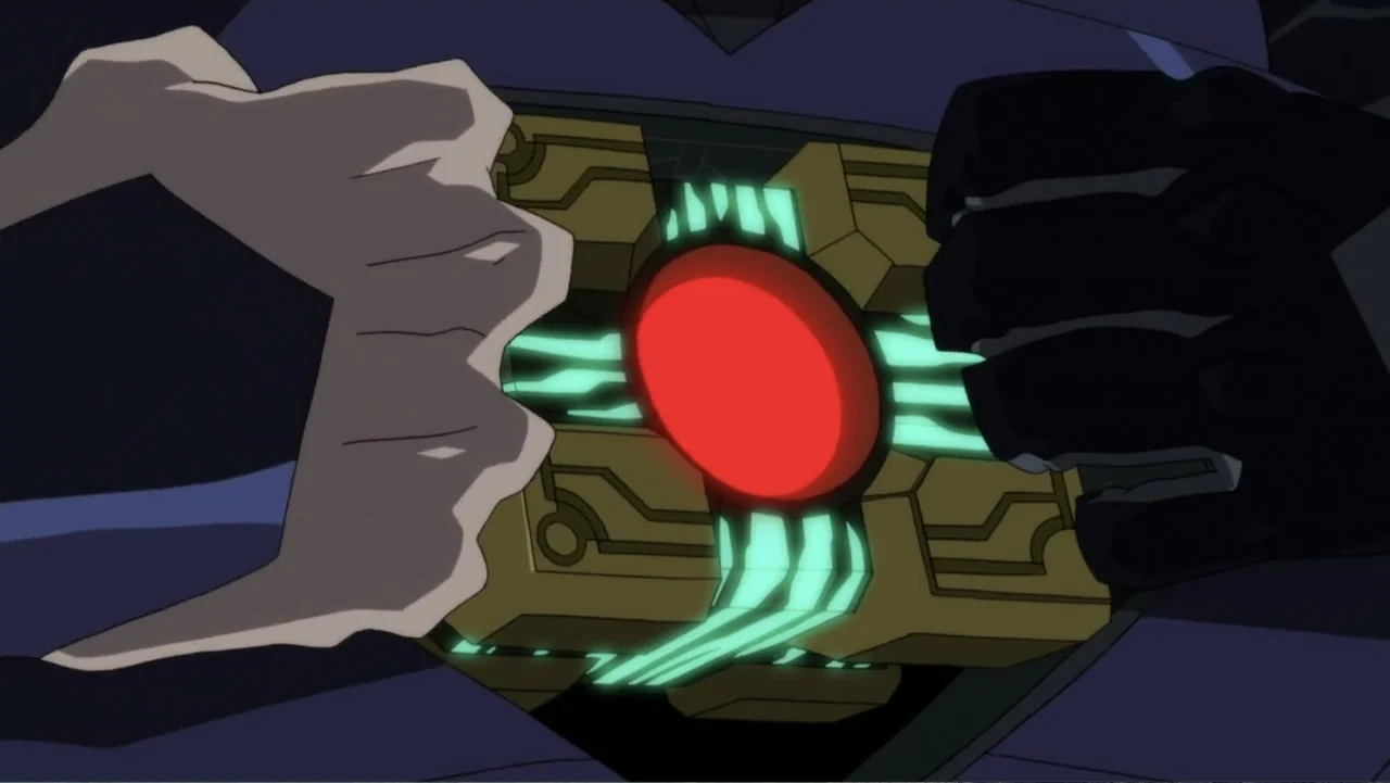 Reign of the Supermen (2019) movie still: closeup — A glowing mechanical object is held by two hands against a dark background. The cube features a…