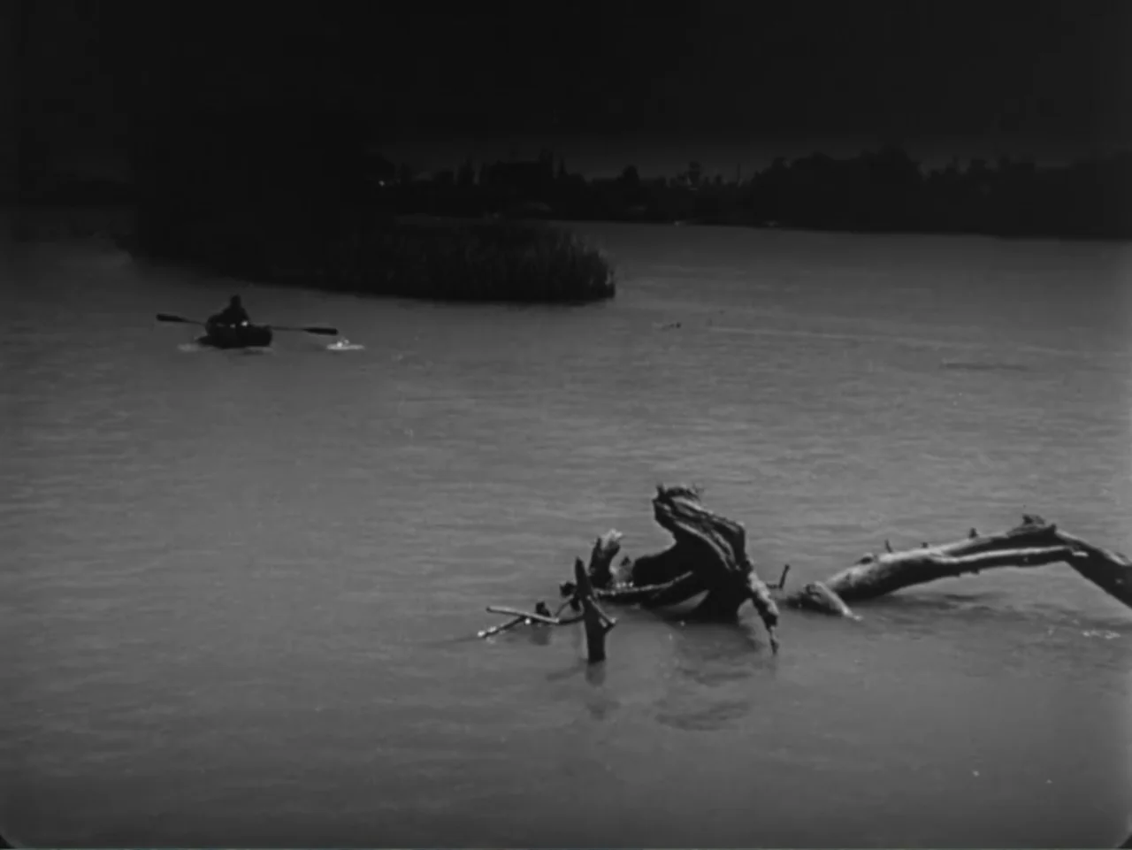 House by the River (1950) movie still: wide — A wide river scene features a small rowing boat and a large floating log. A single individual…