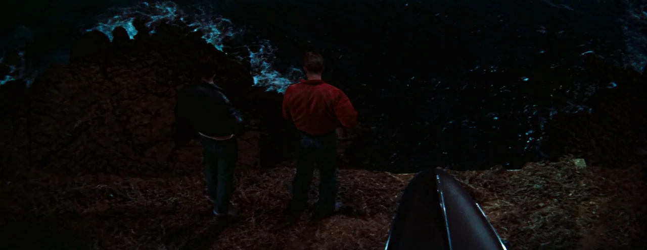 Rebel Without A Cause (1955) movie still: wide — A dark rocky precipice overlooks a churning ocean illuminated by faint moonlight from above. Two…