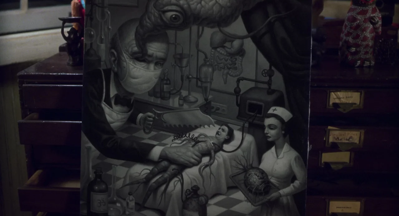Monkeybone (2001) movie still: closeup — A close-up view of a black and white surrealist painting depicting a macabre surgery. The painting is…