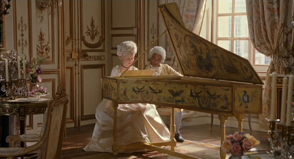 Marie Antoinette (2006) movie still: medium — An opulent 18th-century room features elaborate gilded wall paneling and heavy patterned drapery. A…