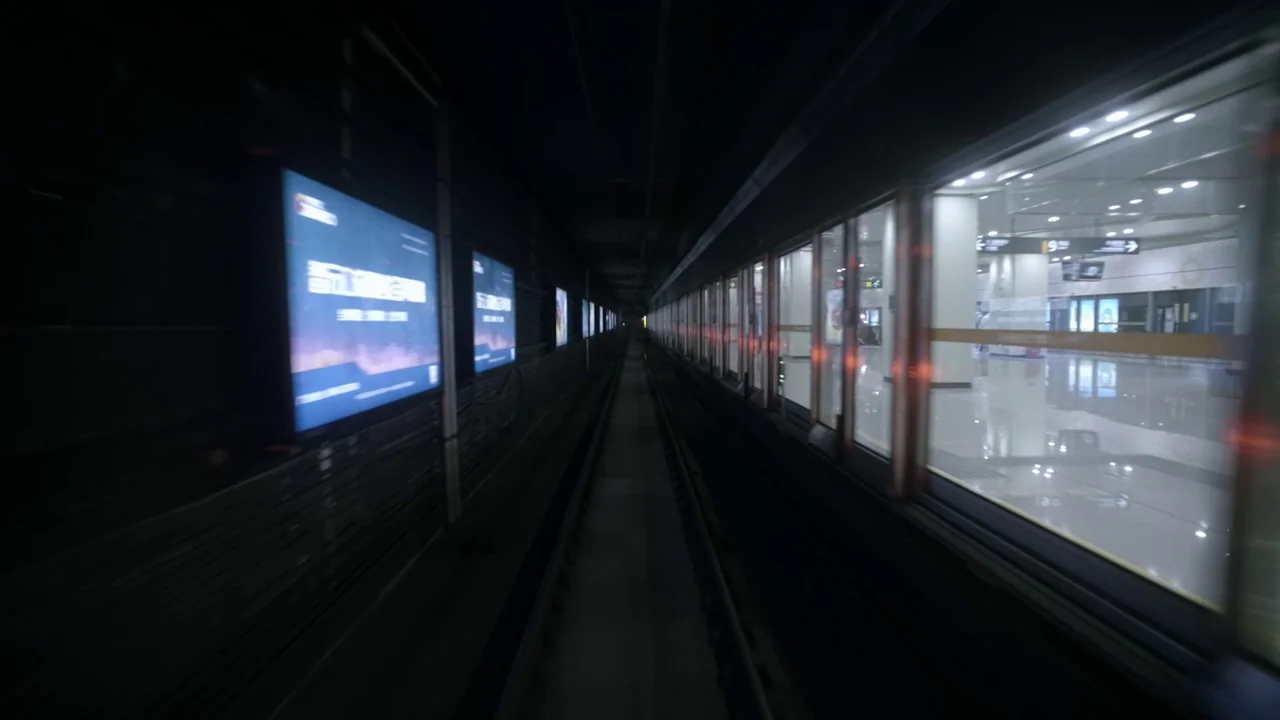 The Last Year of Darkness (2023) movie still: establishing — A subterranean subway tunnel viewed from the perspective of a moving train car. Bright…