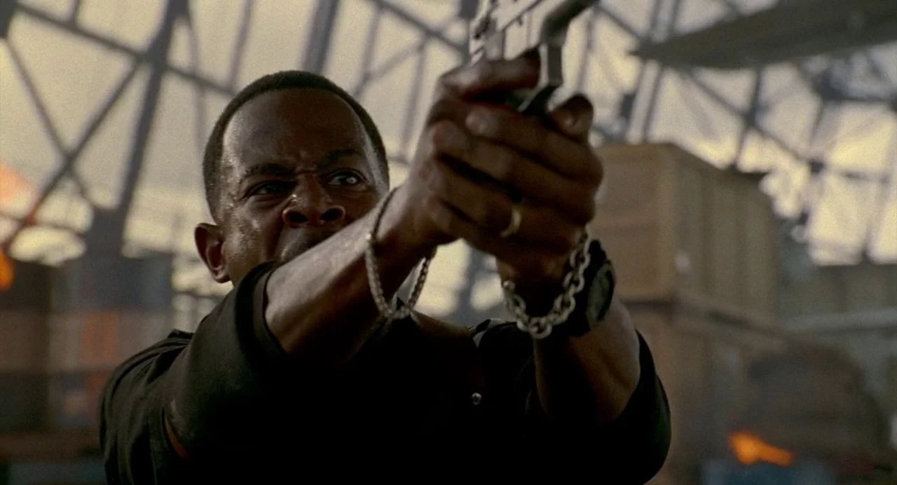Bad Boys (1995) movie still: medium — A high-ceilinged industrial space with exposed metal structural trusses and scattered wooden crates. A man…