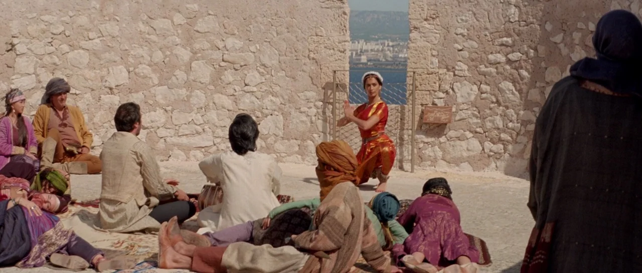 Arabian Nights: Volume 3 The Enchanted One (2015) movie still: wide — An open stone enclosure with a view of a distant cityscape through a gap. A…