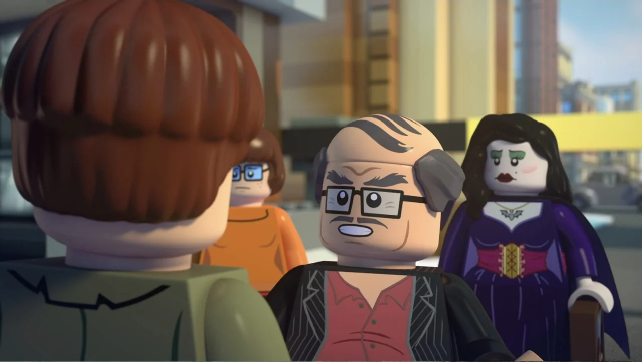 LEGO Scooby-Doo! Haunted Hollywood (2016) movie still: medium — A group of plastic toy-like figures stand together on a paved city sidewalk. A man…