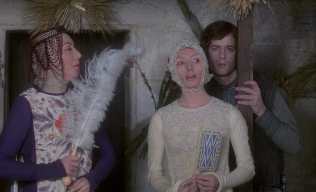 Blanche (1971) movie still: medium — A group of three people in medieval clothing stand inside a rustic stone room. They hold symbolic objects…