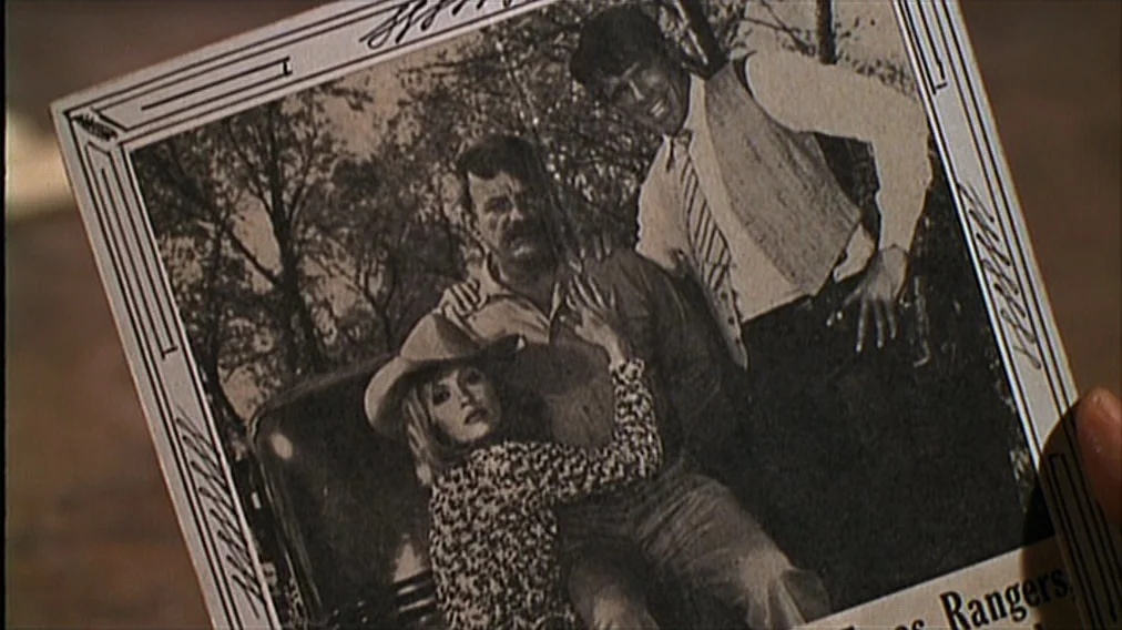 Bonnie And Clyde (1967) movie still: closeup — A close-up insert of a vintage black and white photograph held in a hand. The photo depicts a blonde…