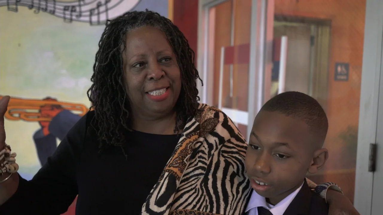 We Are the Dream: The Kids of the Oakland MLK Oratorical Fest (2020) movie still: medium — An interior space features a mural with musical…