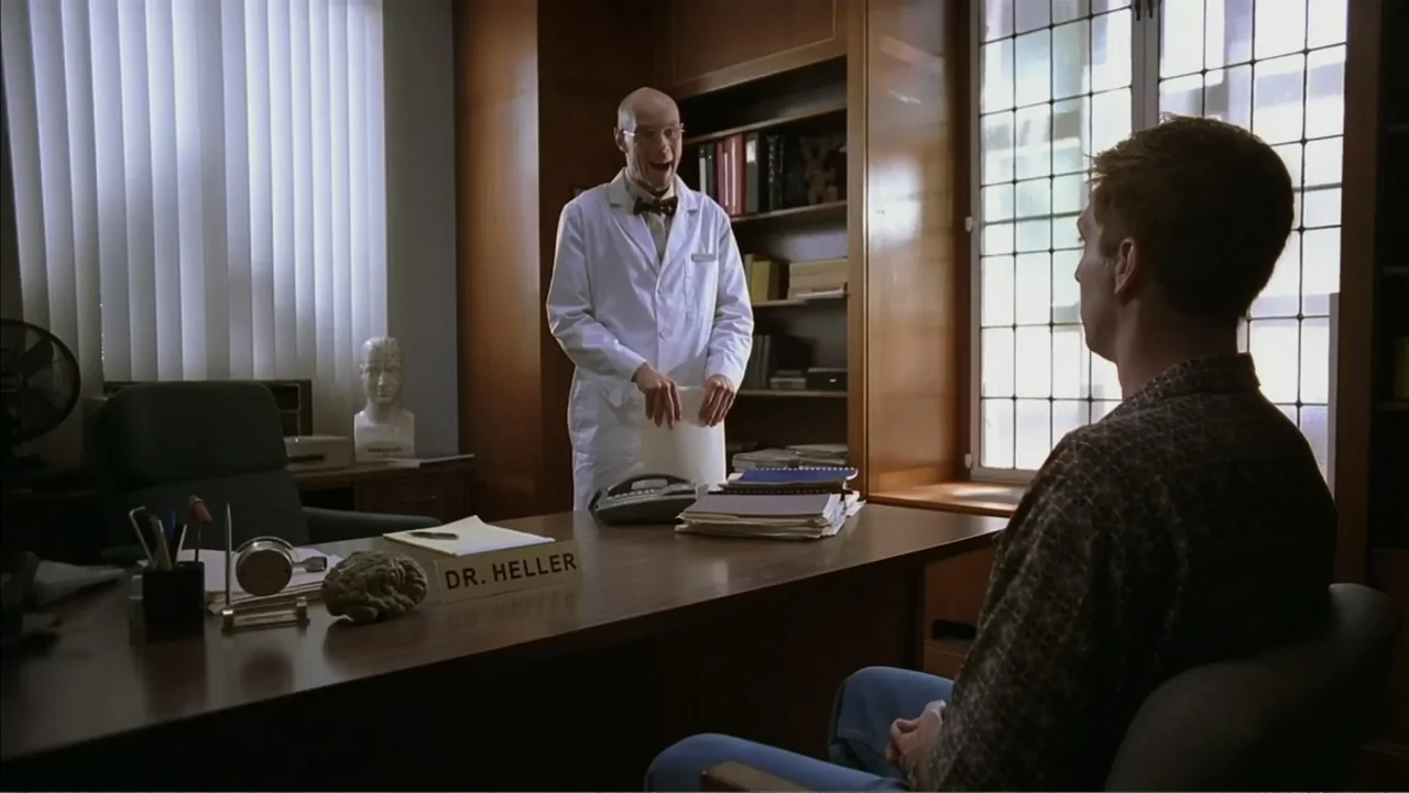 Day of the Dead 2: Contagium (2005) movie still: medium — A wood-paneled office contains a desk with nameplate, bookshelves, and a window with…