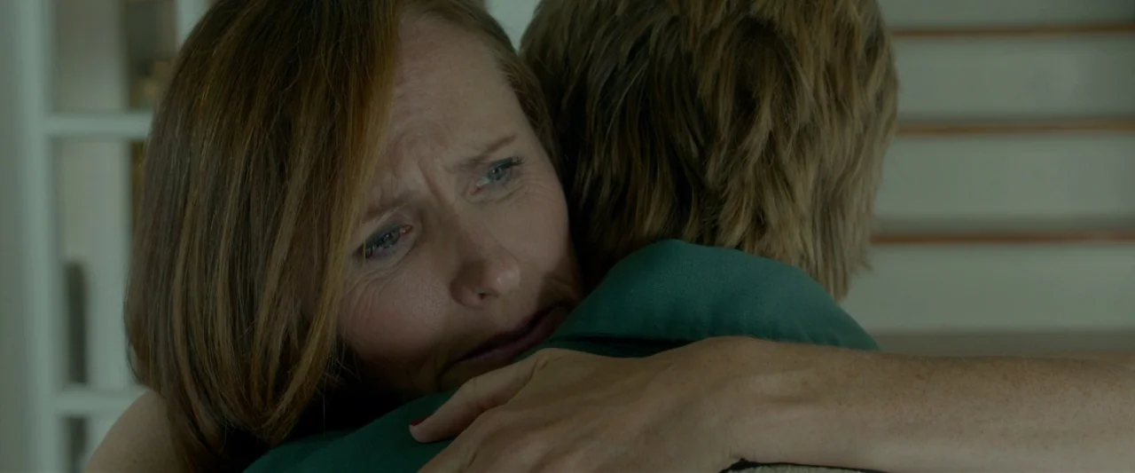 Me and Earl and the Dying Girl (2015) movie still: closeup — A close-up shot focuses on a woman hugging an individual from behind. The woman rests…