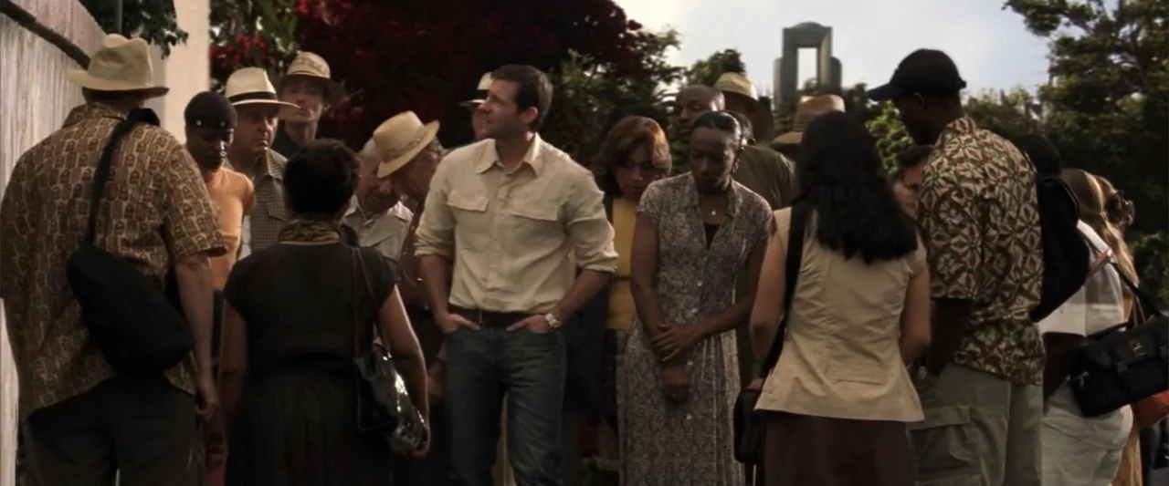 A Sound of Thunder (2005) movie still: medium — An outdoor public space features a diverse group of people standing near a wall. They are gathered…