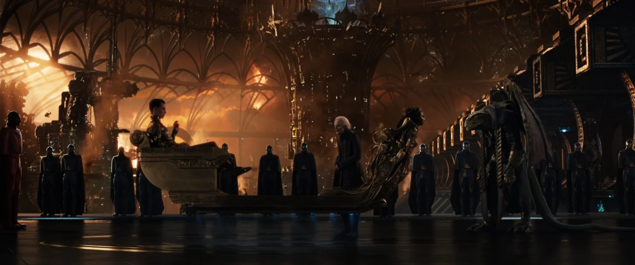 Jupiter Ascending (2015) movie still: wide — A vast, vaulted interior space with metallic arched beams and fiery distant light. A central floating…