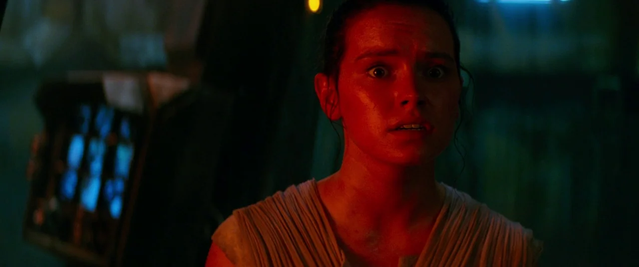 Star Wars: The Force Awakens (2015) movie still: closeup — A dimly lit interior of a futuristic craft featuring an illuminated console display…
