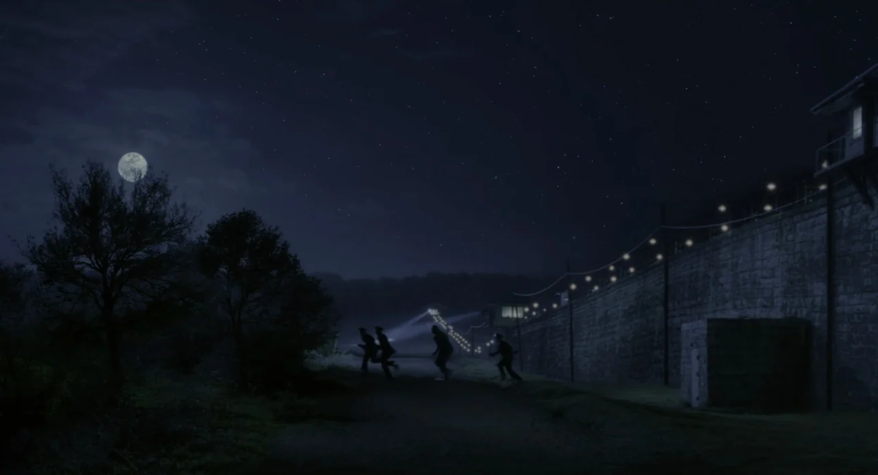 The Green Mile (1999) movie still: wide — A tall stone perimeter wall borders a dark dirt path under a bright full moon. Four silhouetted figures…