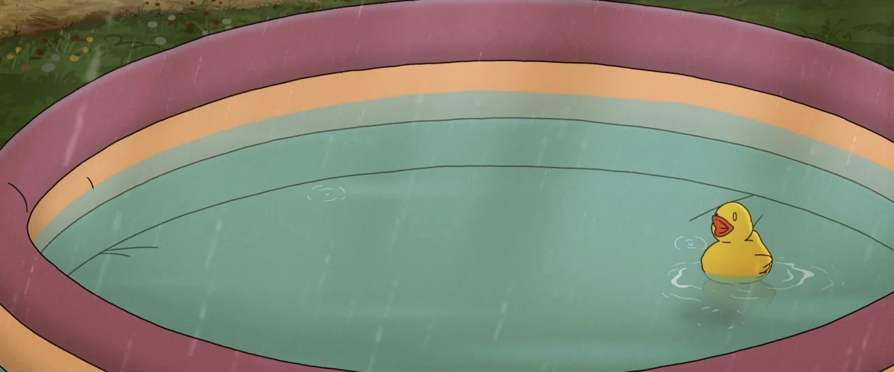 The Ape Star (2021) movie still: medium — An inflatable plastic pool with tiered pastel edges sits on grass during light rain. A single yellow…