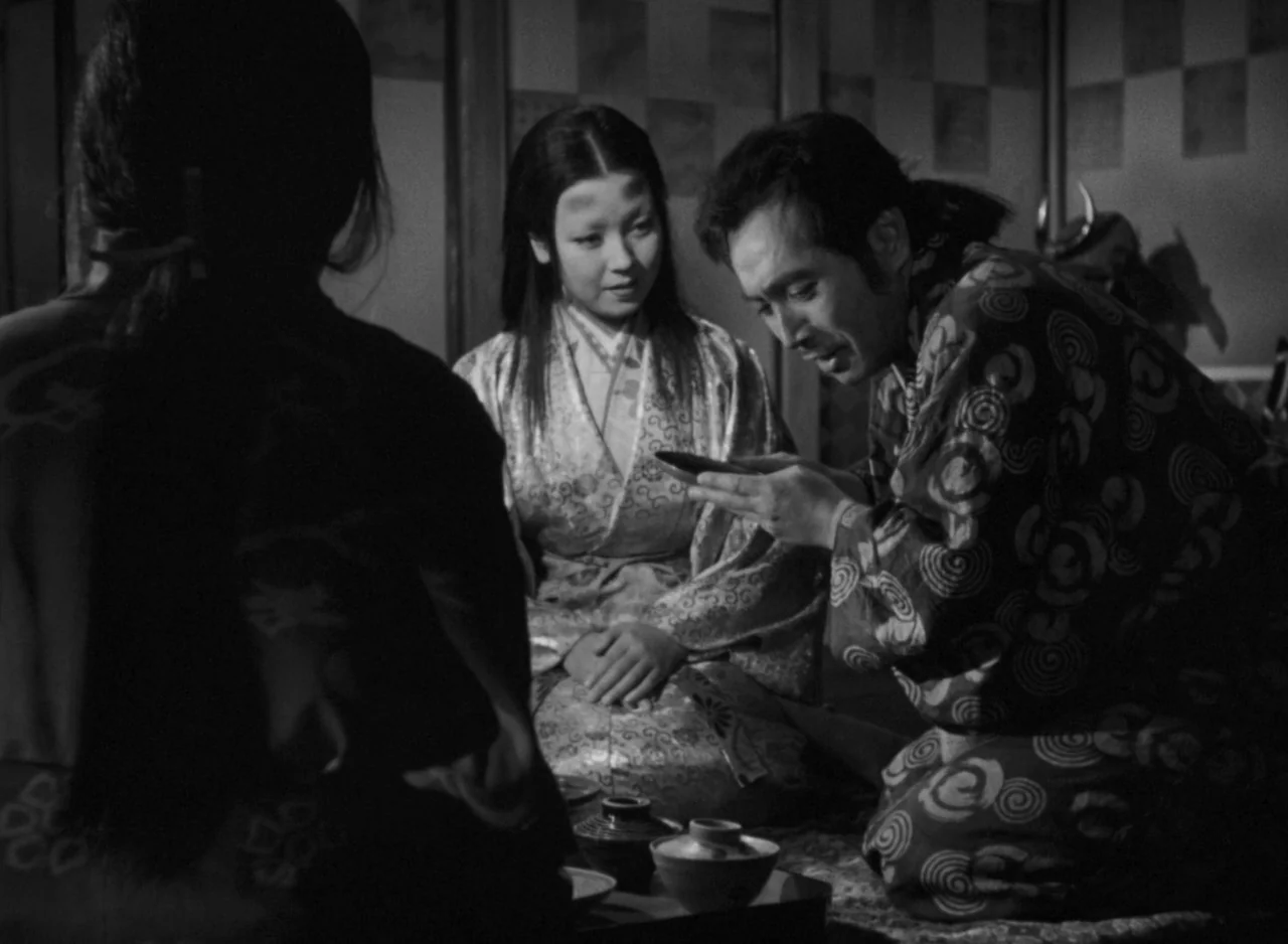 Ugetsu (1953) movie still: medium — A traditional room features shoji screens and low seating on a straw mat. Three individuals sit around a low…