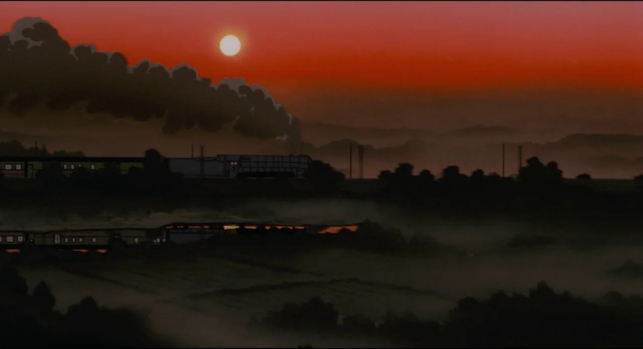 Millenium Actress (2001) movie still: wide — A steam locomotive pulls a line of train cars across a dark, hazy rural landscape. The vibrant sunset…