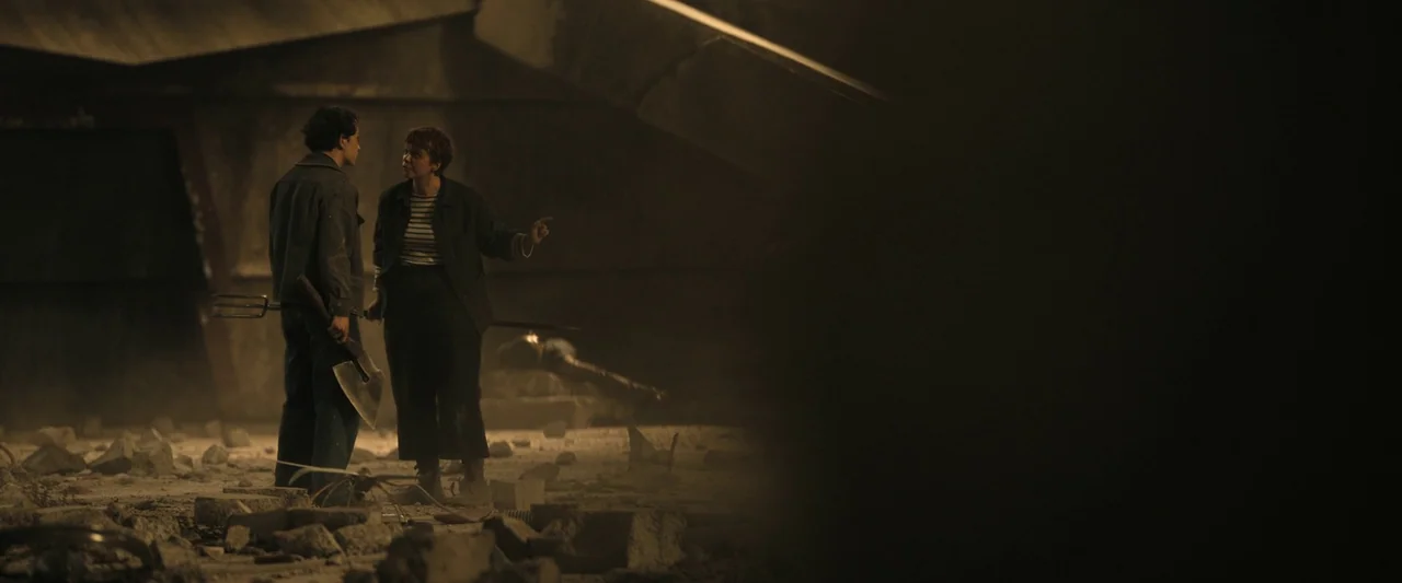 The Hunger Games: The Ballad of Songbirds & Snakes (2023) movie still: wide — An abandoned, rubble-strewn interior space with dark structural beams…